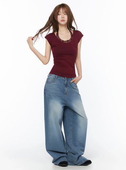 Lace Halter Tee IU525 Dark red full-body front shot on model holding black bag, pearl necklace and braided belt, lace neckline, wide jeans