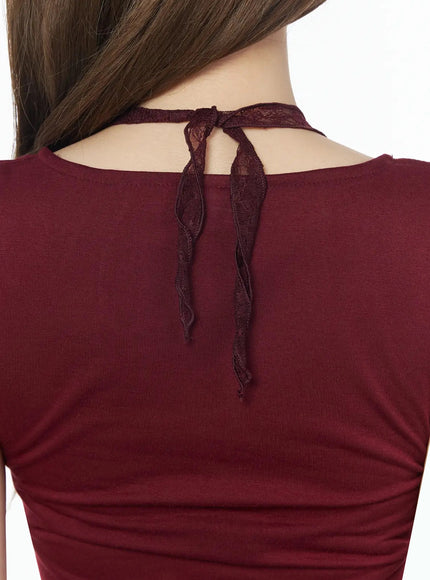 Lace Halter Tee IU525 Dark red close-up back detail shot showing lace ribbon tie bow at neckline against fitted dark red jersey fabric