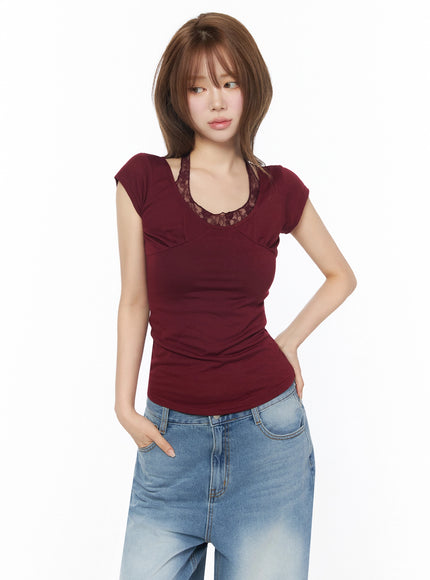 Lace Halter Tee IU525 Dark red half-body front shot on model looking sideways, hand on hip, lace U-neckline, slim ribbed cap sleeve tee