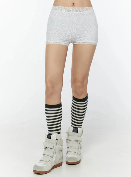 Lace Layered Micro Shorts IU524 White front waist-to-knee shot on model highlighting all-over floral lace pattern lace trim waistband styled with striped knee socks