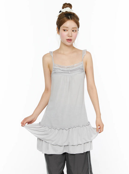 Lace Ruffle Mini Dress CL501 Gray front shot on model lifting ruffle hem to display tiered layers, lace bust neckline, soft knit fabric