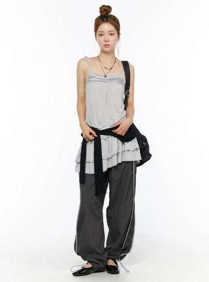 Lace Ruffle Mini Dress CL501 Gray front full-length shot on model standing with necklace and crossbody bag, tiered ruffle hem over track pants