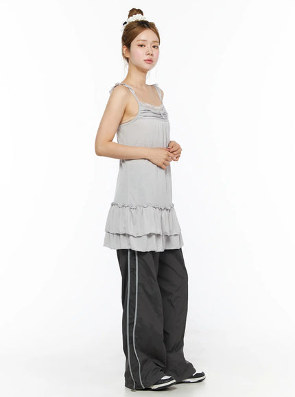 Lace Ruffle Mini Dress CL501 Gray side shot on model, showing lace strap detail and double-tiered ruffle hem silhouette with track pants