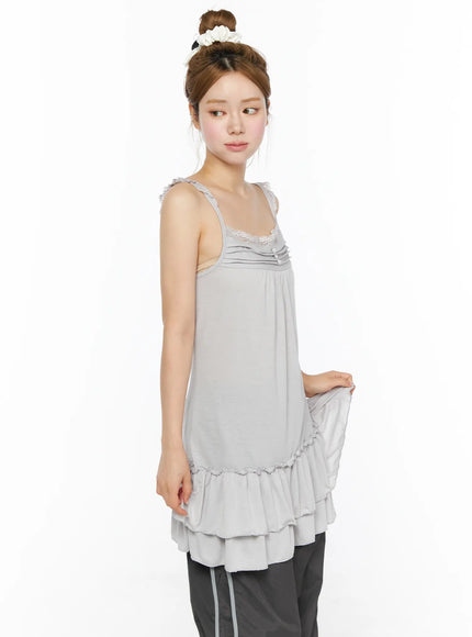Lace Ruffle Mini Dress CL501 Gray side close-up on model lifting hem to show tiered ruffle layers, lace bust detail, soft knit fabric texture