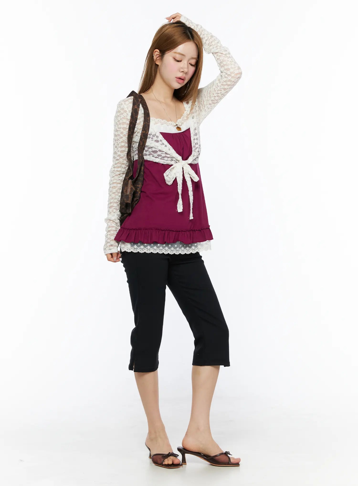Lace Sheer Crop Cardigan CL502 White front shot on model with bag over shoulder looking down, full-length styling with magenta cami and cropped trousers