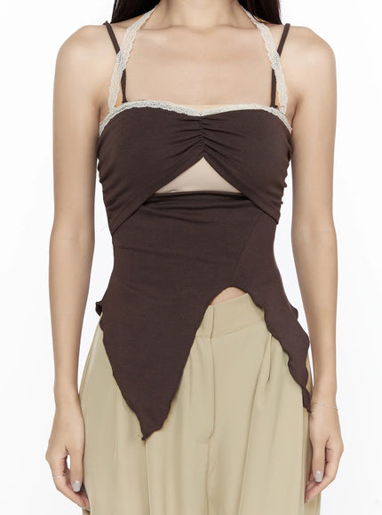 Lace Trim Asymmetric Cami CL524 Brown close-up front shot on model detailing lace trim neckline center ruching triangular cutout and raw-edge asymmetric hemline