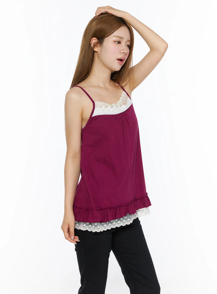Lace Trim Cami Top CL502 Dark red side view on model with hand on head, white lace chest detail and ruffle lace hem visible, black pants