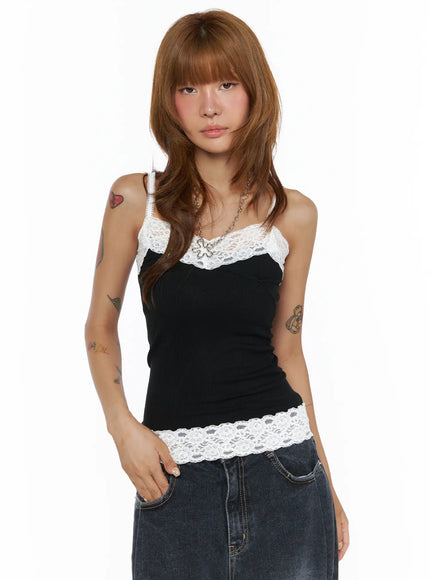 Lace Trim Cami Top CL503 Black front view on model wearing black ribbed cami with white floral lace neckline and lace hem trim, styled with denim skirt