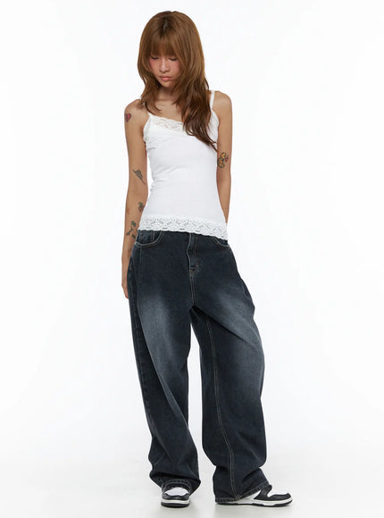 Lace Trim Cami Top CL503 White full-body front shot on model looking down, showing ribbed fabric and floral lace hem, paired with wide-leg washed jeans and sneakers