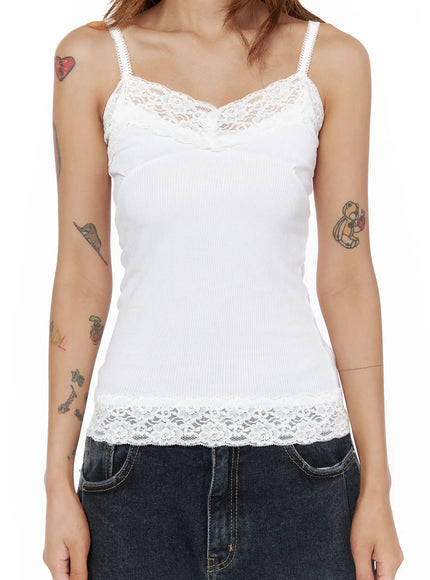 Lace Trim Cami Top CL503 White close-up front detail shot on model showing floral lace V-neckline panel and wide lace hem trim on ribbed cami body