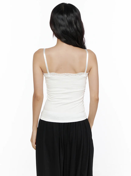 Lace Trim Cami Top CL513 White back view on model, thin adjustable straps, floral lace trim along straight back neckline, fitted ribbed knit construction