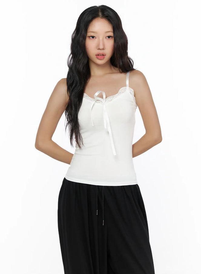 LEWKIN Lace Trim Cami Top CL513 White front view on model, cropped half-body, satin ribbon tie neckline with floral lace trim, slim ribbed knit, size S/M
