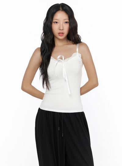 LEWKIN Lace Trim Cami Top CL513 White front view on model, cropped half-body, satin ribbon tie neckline with floral lace trim, slim ribbed knit, size S/M
