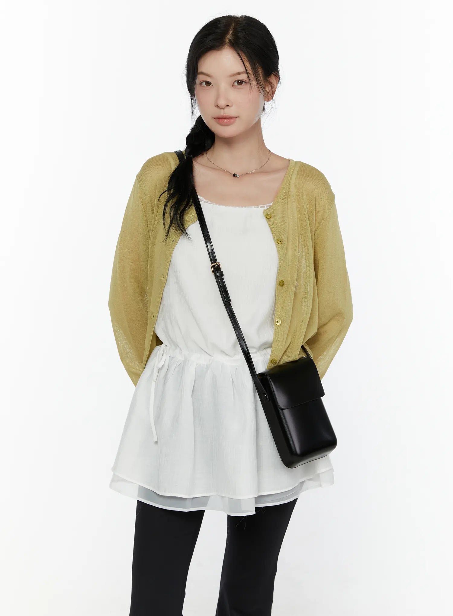 Lace Trim Cami Top CL520 White front view on model layered under olive knit cardigan with black crossbody bag showing lace neckline and drawstring waist detail