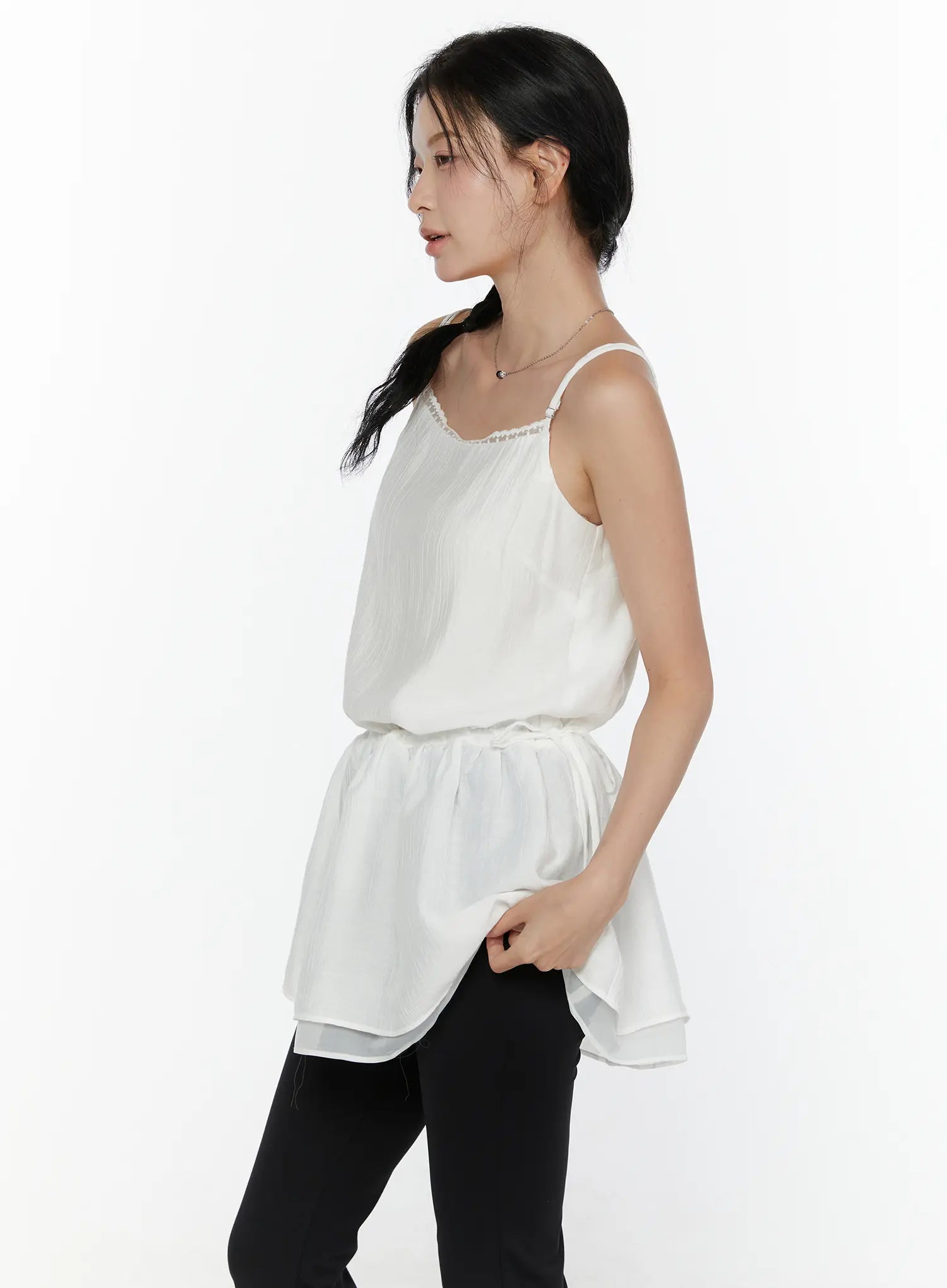 Lace Trim Cami Top CL520 White side view on model showing crinkle chiffon body drawstring waist gathered peplum and double-layer sheer hem with black leggings