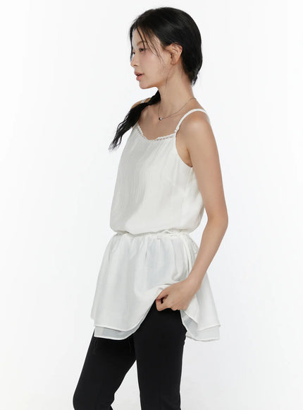 Lace Trim Cami Top CL520 White side view on model showing crinkle chiffon body drawstring waist gathered peplum and double-layer sheer hem with black leggings
