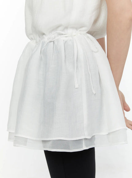 Lace Trim Cami Top CL520 White close-up detail shot of drawstring waist tie gathered peplum hem and double-layer sheer organza hem in crinkle chiffon