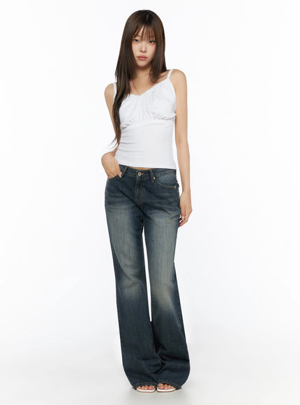 Lace Trim Cami Top IL523 White full-length front shot on model standing straight, lace trim neckline, empire waist detail, styled with wide-leg flare jeans