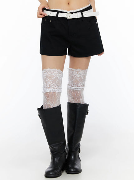 Lace Trim Cotton Shorts IL523 Black front lower-body shot on model with hand on hip, showing lace waistband and white floral lace over-knee socks with black buckle boots