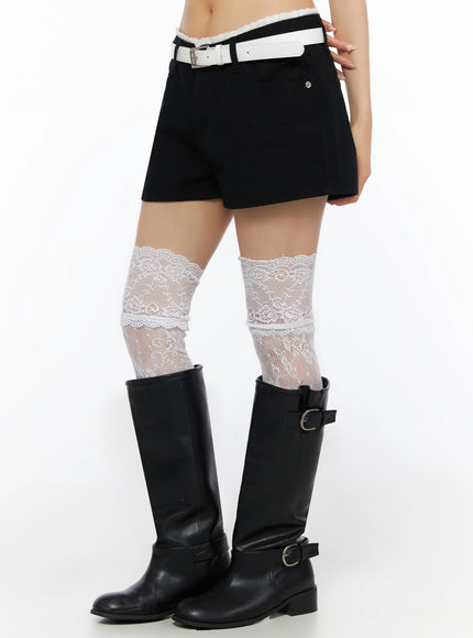 Lace Trim Cotton Shorts IL523 Black side lower-body shot on model highlighting scalloped lace waistband trim, white lace knee socks tucked into black riding boots
