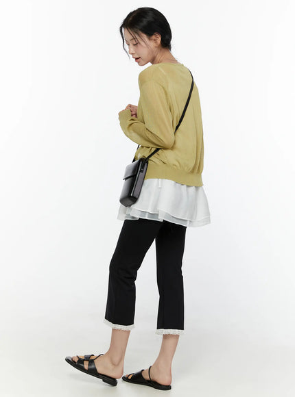 Lace Trim High-Waist Capri Pants CL520 Black three-quarter back styling shot on model wearing yellow cardigan white layered top looking down with black crossbody bag