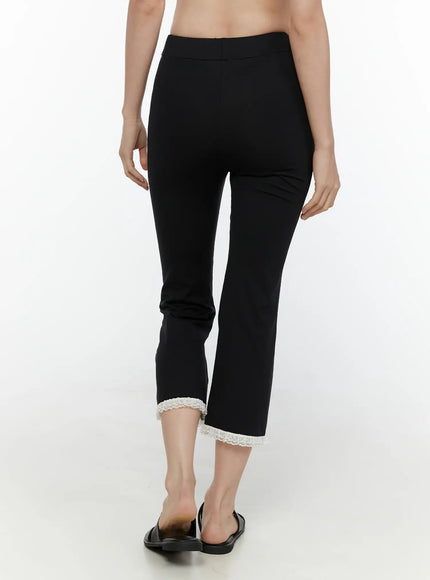 Lace Trim High-Waist Capri Pants CL520 Black back view on model showing smooth high waistband fitted seat cropped flare hem with white lace trim and sandals
