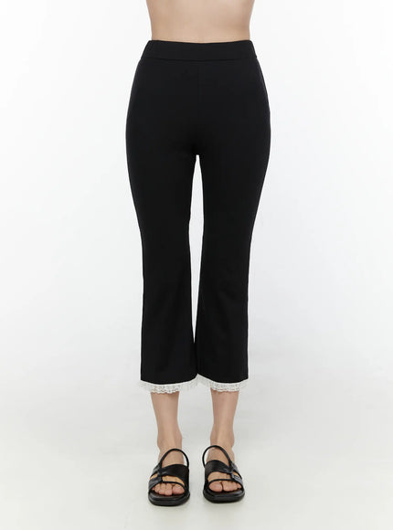 LEWKIN Lace Trim High-Waist Capri Pants CL520 Black front view on model size S/M showing slim fit cropped flare silhouette with white lace hem trim and black sandals