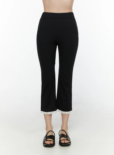 LEWKIN Lace Trim High-Waist Capri Pants CL520 Black front view on model size S/M showing slim fit cropped flare silhouette with white lace hem trim and black sandals