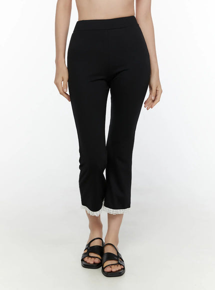 Lace Trim High-Waist Capri Pants CL520 Black front view on second model showing high waistband slim cropped flare fit with white lace trim hem and black sandals