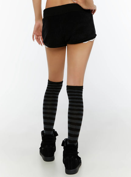 Lace-Trim Layered Shorts IL524 Black back shot on model showing smooth velour back and white lace trim hem, styled with striped knee-high socks