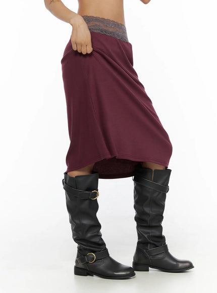 Lace Trim Midi Skirt CL503 Dark red side shot on model lifting skirt hem revealing flared silhouette and gray lace waistband, with black boots