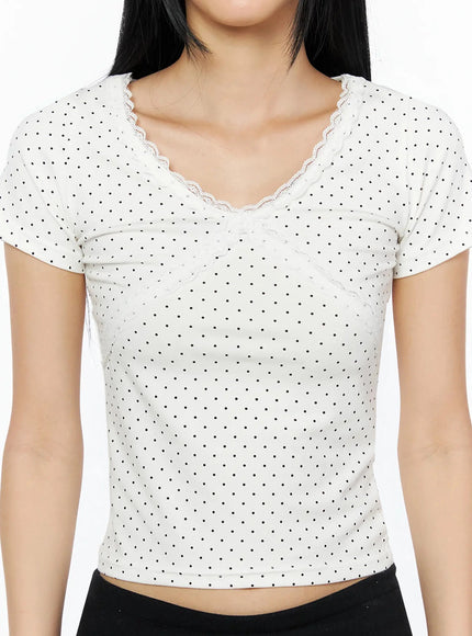 Lace Trim Polka Dot Top IL509 White close-up front detail shot on model showing lace V-neckline and lace seam panel on polka dot fabric