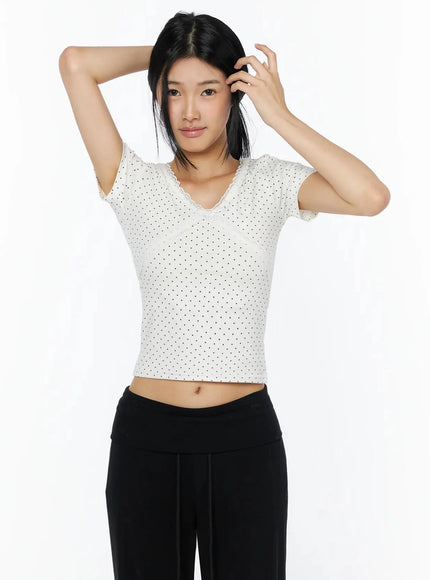 Lace Trim Polka Dot Top IL509 White front shot on model with arms raised overhead, cropped fit with lace trim neckline and lace hem detail