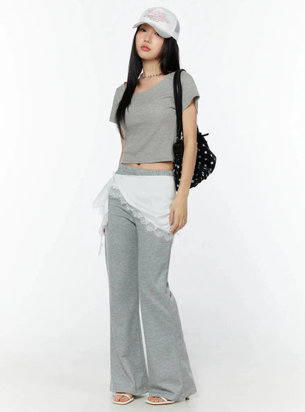 Lace Trim Satin Layering Skirt IU524 White front full-body shot on model styled with gray crop tee, cap, and polka-dot bag over gray flare pants