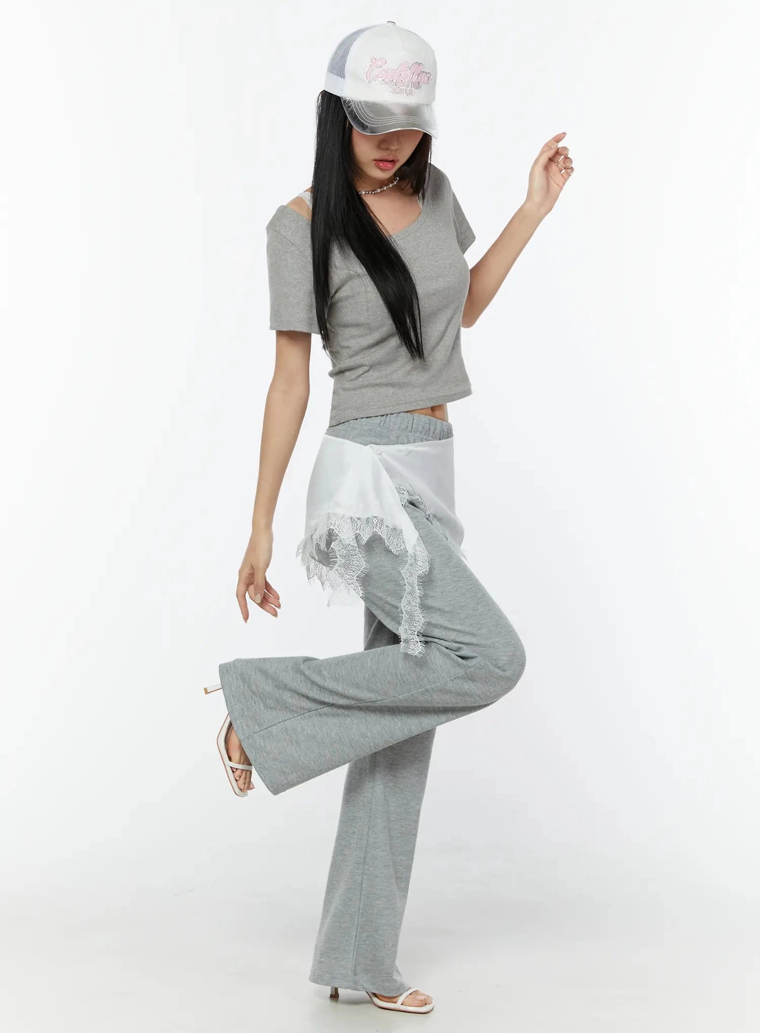 Lace Trim Satin Layering Skirt IU524 White full-body dynamic pose on model with one leg raised wearing cap and heels with gray crop top showing lace hem movement