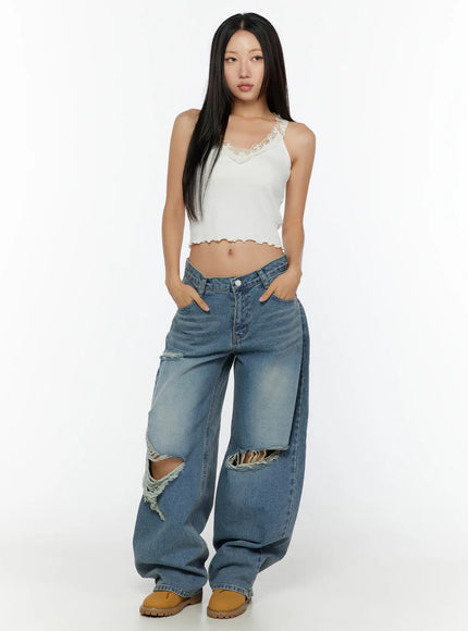 Lace Trim Tank CU526 White full-body front view on model standing with hands in pockets, lace V-neck trim, lettuce hem, paired with wide-leg ripped jeans