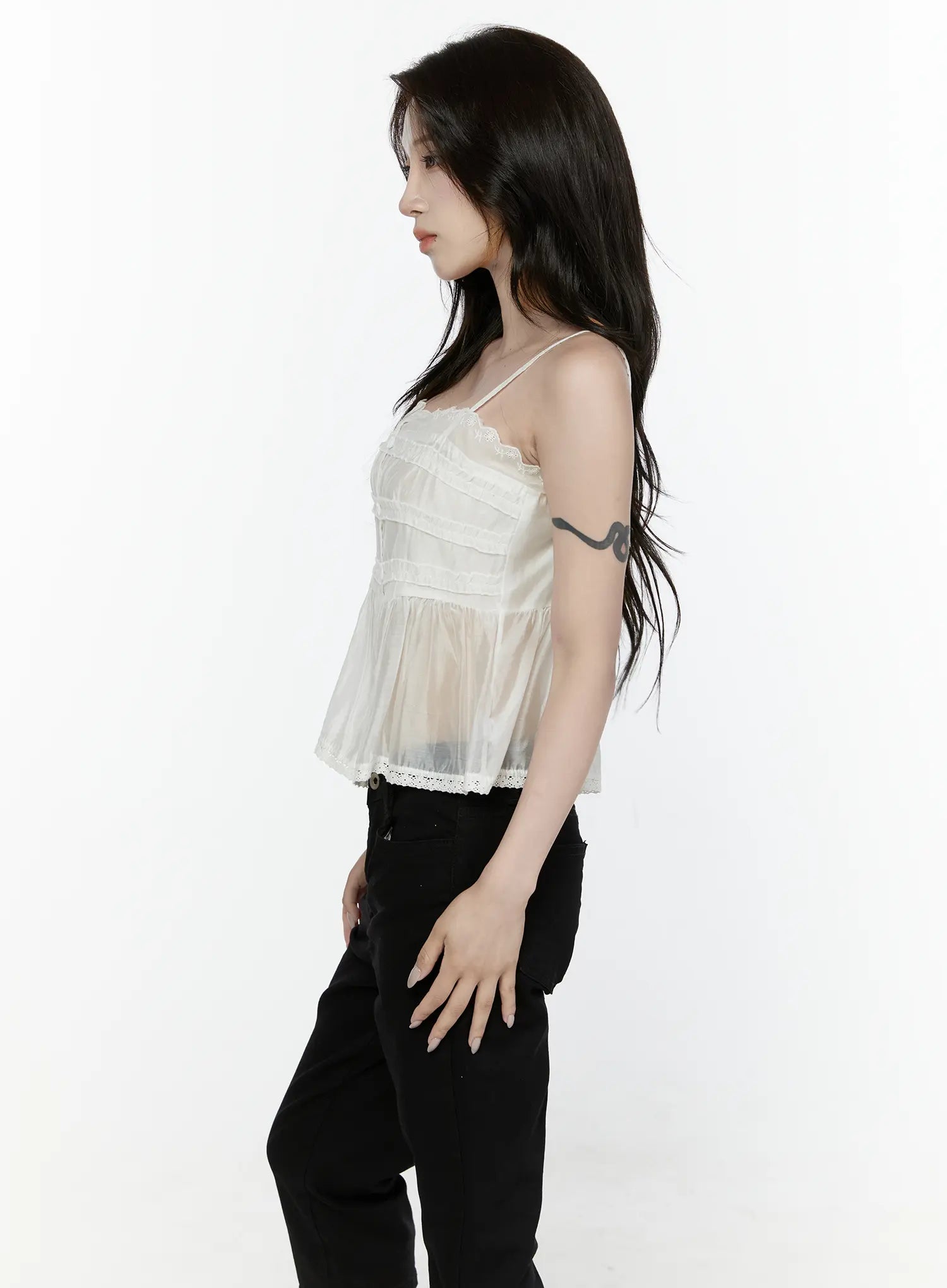 Lace Trim Tank IL521 White side shot on model showing sheer organza silhouette tiered ruffle panels and lace trim hem with black pants