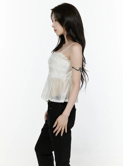 Lace Trim Tank IL521 White side shot on model showing sheer organza silhouette tiered ruffle panels and lace trim hem with black pants