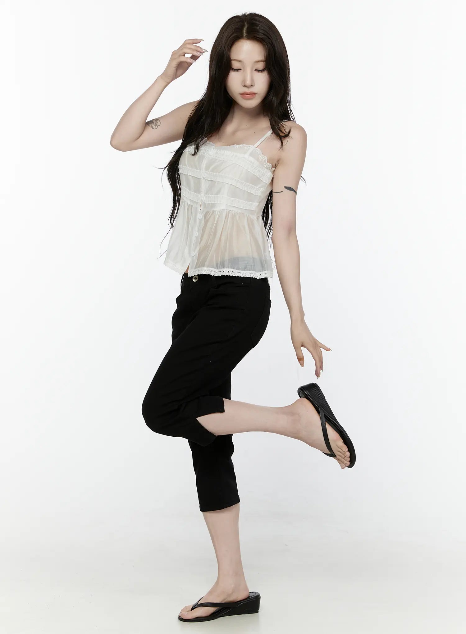 Lace Trim Tank IL521 White front shot on model in dynamic pose one leg raised arm raised showing sheer peplum hem and lace trim