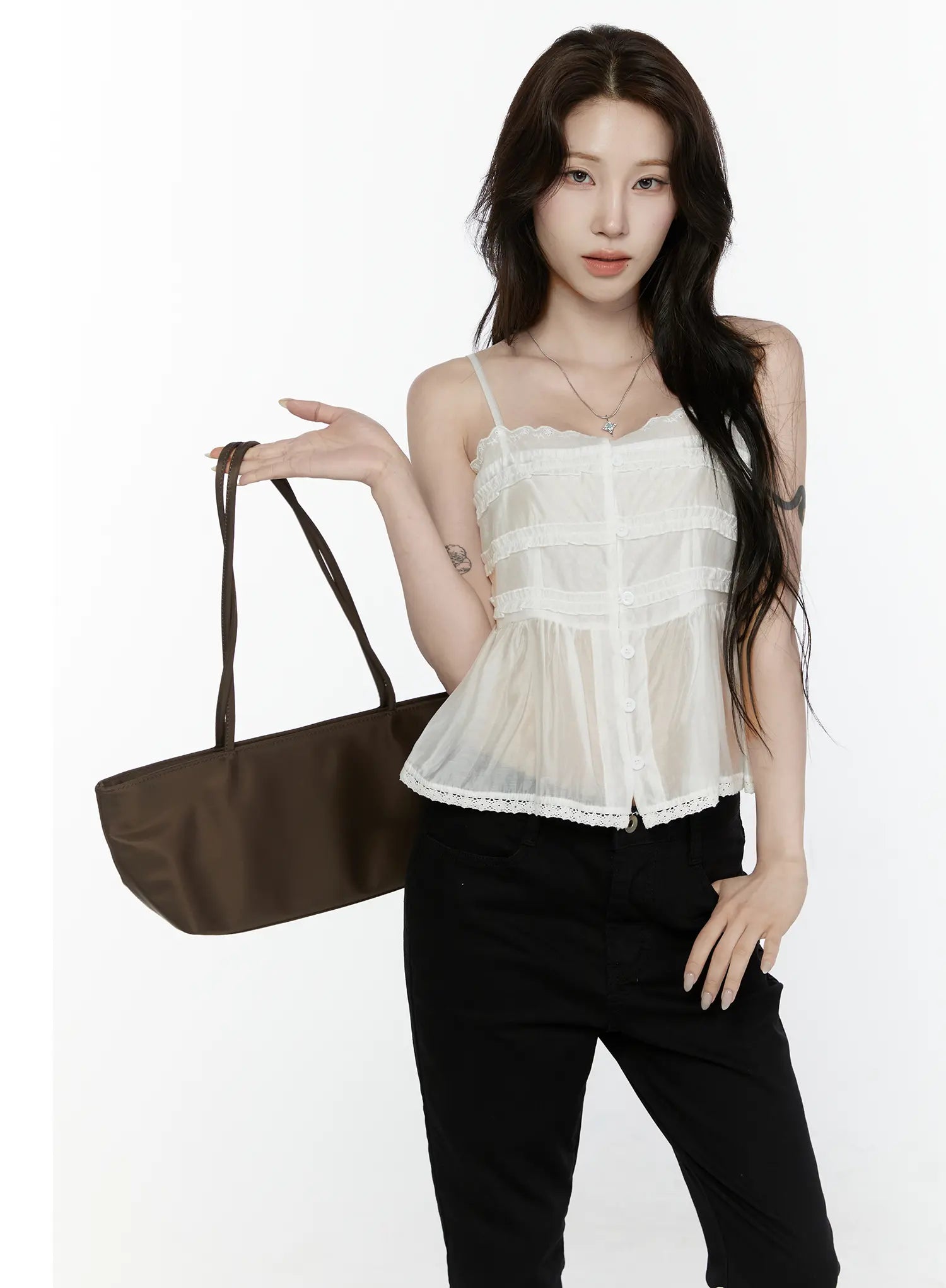 Lace Trim Tank IL521 White front shot on model holding brown tote bag raised arm pose showing tiered ruffle bodice and button placket
