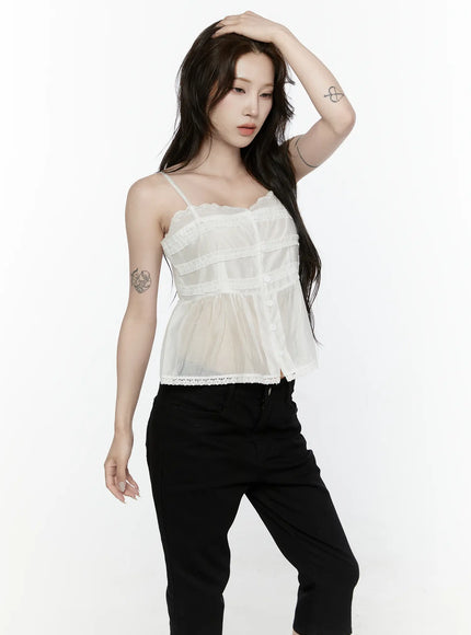 Lace Trim Tank IL521 White front shot on model hand raised to head showing lace neckline ruffle tiers button front and flowy sheer hem