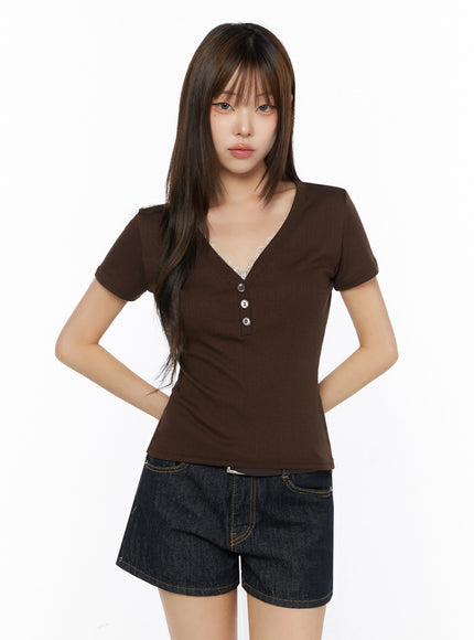 Lace Trim V-Neck Tee IL523 Brown front model shot hands behind back styled with dark denim shorts lace trim V-neck ribbed fitted tee