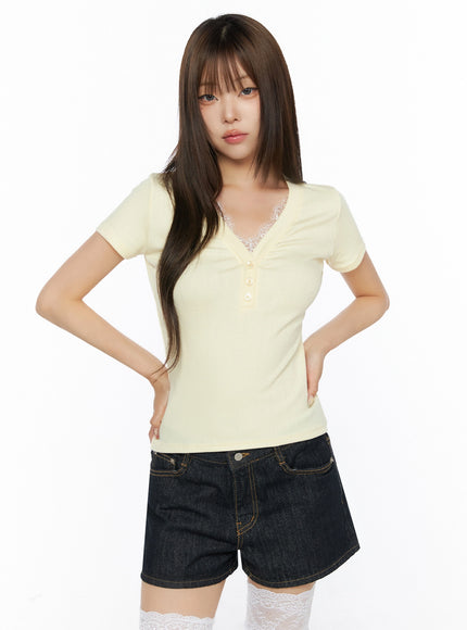 Lace Trim V-Neck Tee IL523 Yellow front model shot hands on hips with lace neckline detail dark denim shorts and white lace thigh socks