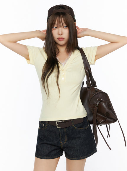 LEWKIN Lace Trim V-Neck Tee IL523 Yellow S/M front model shot hands raised behind head with brown cap bag and denim shorts ribbed knit