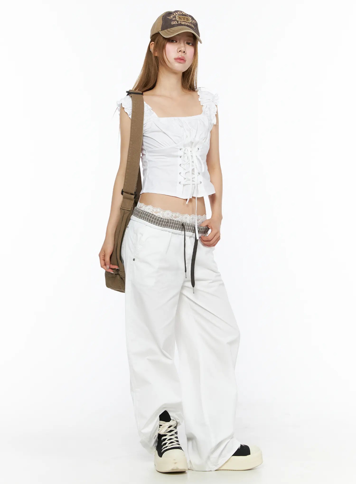 Lace-Up Corset Blouse Top CL502 White full-body front shot on model styled with cap crossbody bag and wide-leg pants showing complete casual outfit