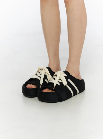 LEWKIN Lace-Up Slide Slippers CU530 Black side view on model, open-toe platform mule with cream lace-up detail and stripe, size 230/US6