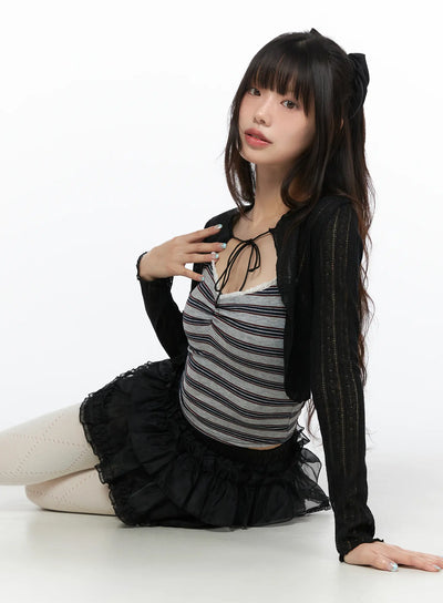 LEWKIN Lace V-Neck Striped Top CL522 Gray S/M seated model wearing black sheer knit cardigan over striped cami styled with black tiered tulle skirt and white tights