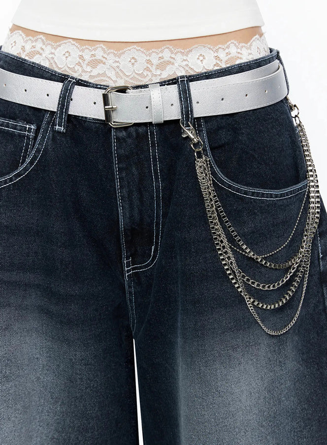 LEWKIN Layered Belt Chain IL516 Silver close-up detail on model showing multi-strand silver chains clipped to white leather belt over dark wash jeans with lace waistband visible
