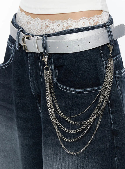 Layered Belt Chain IL516 Silver close-up side detail on model wearing white tank and dark jeans with silver layered chains draped from white leather belt at hip