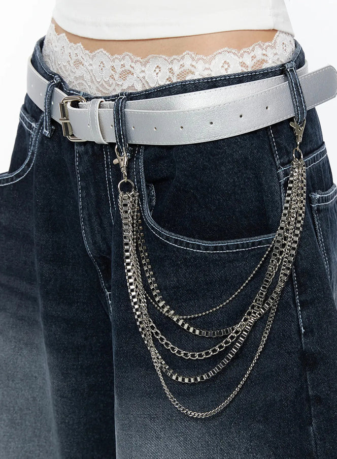 Layered Belt Chain IL516 Silver close-up side detail on model wearing white tank and dark jeans with silver layered chains draped from white leather belt at hip
